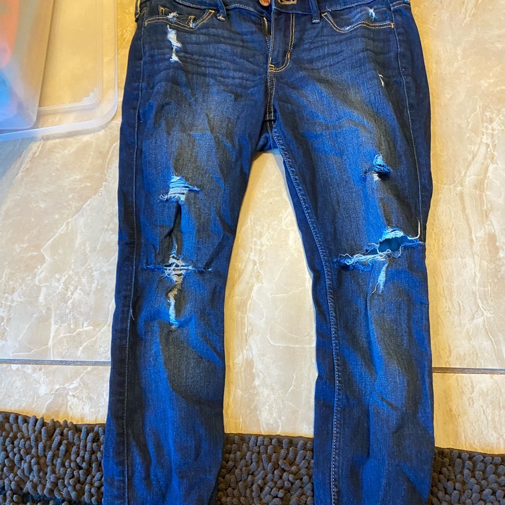Dark wash low rise ripped jeans
